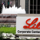 The Eli Lilly corporate center with a fountain in the background a sign reading "Lilly Corporate Center."